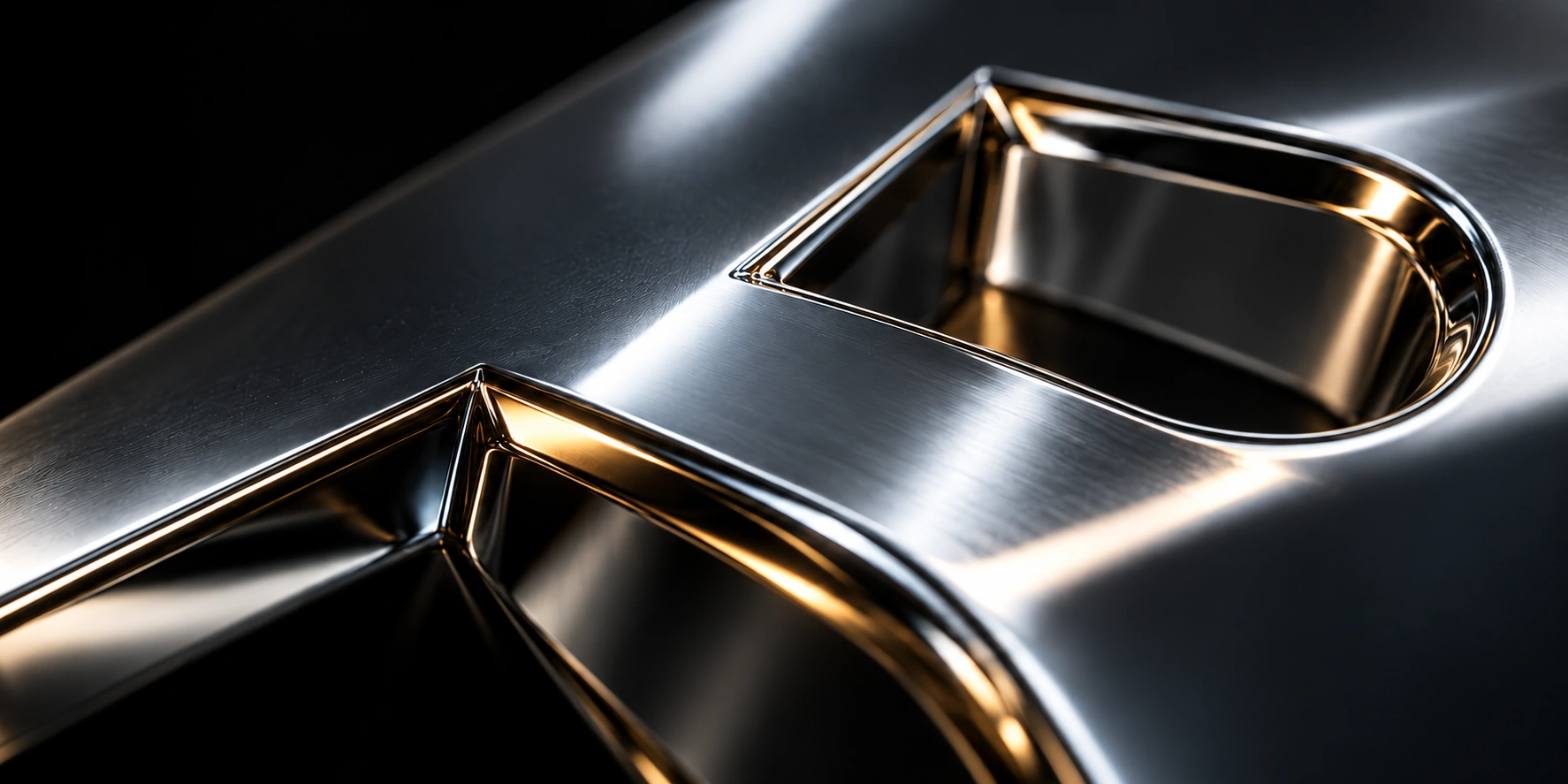 Illustrative close-up of a chrome letter with a gold bevel.